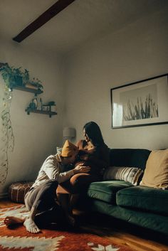 two people sitting on a couch in a living room