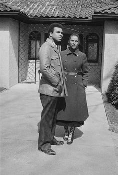 two people standing in front of a building