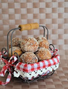 a basket filled with donuts covered in powdered sugar