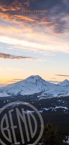 the sun is setting over some mountains with snow on them and clouds in the sky