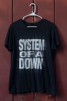 Vintage, 90s, System Of A Down, Nu Metal, Band Promo TShirt Size Medium Material: 100% Cotton: Pre-Shrunk to perfection Shirt is in excellent condition, no holes, no stains and extremely soft!  Check out other sensational vintage rock tees in my shop: https://www.etsy.com/shop/ThisCharmingManCo?section_id=26210402 Note: Please keep in mind, all of my items are 100% authentic vintage. This means they are not new and may show natural signs of wear and age.  I do my very best to make note of any and all flaws in the item description but there may be something tiny that we overlook. When buying vintage clothing online, it is important that you know the measurements of your own clothes that fit you best.  Marked sizes on vintage garments differ from brand to brand, era to era and even within ga 90s Band Shirts, Metal Band Tees, Art Stall, Grunge Tshirt, Vintage Rock Tees, Vintage Band Shirts, Y2k Shirts