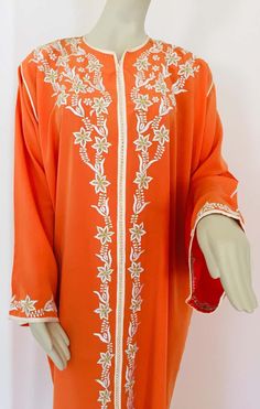 For Sale on 1stDibs - Elegant Moroccan caftan orange color embroidered with gold trim, circa 1970s. This long maxi dress kaftan trim is embroidered and embellished with pearls Long Sleeve Orange Kaftan For Spring, Orange Long Sleeve Kaftan For Spring, Orange Long Sleeve Spring Kaftan, Traditional Long Sleeve Orange Kaftan, Traditional Orange Tunic Kaftan, Traditional Orange Maxi Kaftan, Hand Embellished Long Sleeve Kaftan For Eid, Embellished Long Kaftan For Spring, Orange Embroidered Floor-length Dress