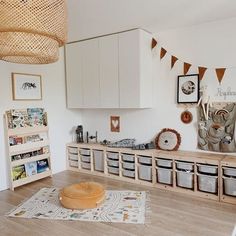 a living room filled with furniture and lots of storage space next to a wooden floor