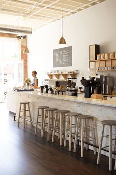 a coffee shop with lots of counter space and stools