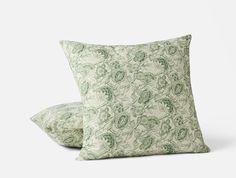 two green pillows sitting on top of each other