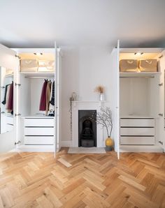 an empty room with white walls and wood flooring on the wooden floor, there is a fireplace in the center