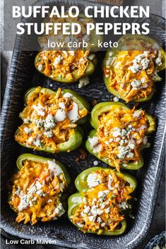 stuffed peppers with cheese and sauce in a baking dish on a black tray text reads buffalo chicken stuffed peppers low carb - keto