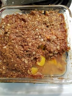 a casserole dish with fruit and crumbs in it