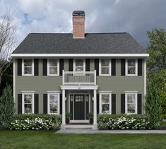 a large gray house with black shutters and white trim