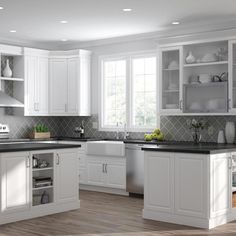 a large kitchen with white cabinets and black counter tops is pictured in this image, it appears to be empty