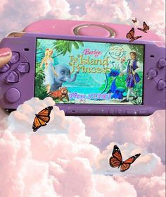 a person holding up a video game device in the air with butterflies flying around it