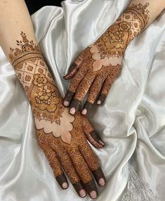 two hands with henna designs on them