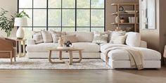 a living room filled with furniture and a large window in the wall above it's windowsill