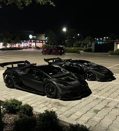 two black sports cars parked in a parking lot