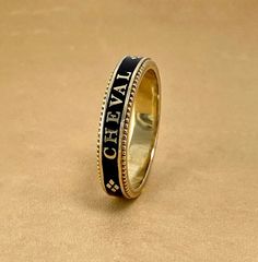 A slim stackable version of our Equus Enamel Ring. Beautiful combination of black enamel and 18 karat yellow gold. 4mm wide Equus (Latin for horse) Cheval (French for horse), stars and a snaffle bit in a continual pattern. Fine beaded detail on both edges. Absolutely gorgeous stacked with the Slim Lace Rein & Diamond Stack rings! Create your own combination! Hand made in the US Made to order, please allow 4-6 weeks for delivery. Luxury Enamel Ring With Polished Finish, Gold Enamel Ring With Black Detail For Formal Occasions, Luxury Black Enamel Ring, Yellow Gold Enamel Ring With Black Enamel As Gift, Yellow Gold Ring With Black Enamel For Gift, Formal Yellow Gold Enamel Ring With Black Details, Formal Yellow Gold Ring With Black Enamel, Formal Yellow Gold Black Enamel Ring, Elegant Engraved Enamel Ring