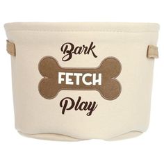 a white storage basket with a brown dog bone on the front that says bark fetch play