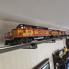 a toy train is on the tracks in a room