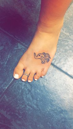 a small elephant tattoo on the foot