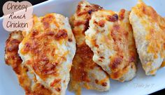 three cheesy chicken patties in a white casserole dish