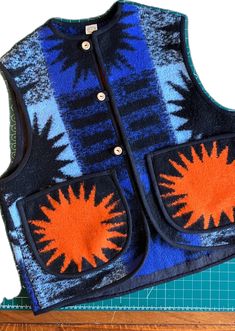 Vest/gilet hand made from a reclaimed vintage blanket with orange suns on the pockets Recycled Blankets, Semi Formal Outfit, Recycled Clothing, Sewing School, Blanket Coat, Repair Clothes, Ethical Fashion Brands, Casual Outfit Inspiration, Wooden Buttons