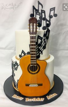 a guitar cake with musical notes on it