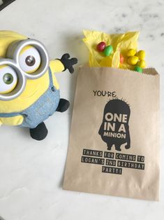 a minion toy next to a brown paper bag