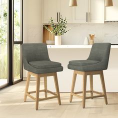 two stools sit in front of a kitchen island