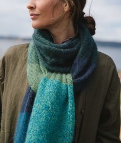 a woman wearing a blue and green scarf