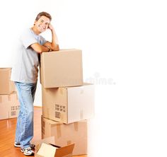 a man is standing next to boxes on the floor