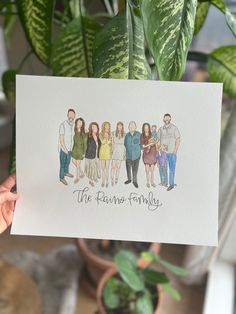 a person holding up a card with an image of people in the same family on it