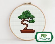 a cross - stitch pattern of a bonsai tree on a white background with the text pot pattern below it