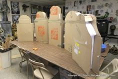 several cardboard boxes sitting on top of a wooden table