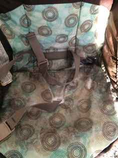 a baby car seat cover with circles on it