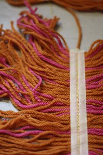 some orange and pink yarn on a table