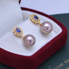 Make a lasting impression with the 11-12mm Freshwater Pearl & Blue Gem Cubic Zirconia Earrings-. These gorgeous earrings are set in a vintage-inspired silver alloy setting and feature shimmering white freshwater pearls and blue Cubic Zircoina gems. The combination of these two elements will bring a touch of elegance to any look, making them perfect for any occasion. Showcase your style and sophistication with this timeless piece from House of Pearls. This popular earrings design features AAAA qu Blue Pearl Earrings For Formal Occasions, Blue Pearl Earrings For Formal Events, Blue Pearl Earrings Fine Jewelry For Formal Events, Luxury Blue Pearl Earrings For Anniversary, Luxury Blue Pearl Drop Earrings, Elegant Blue Pearl Earrings For Anniversary, Blue Round Pearl Earrings For Anniversary, Classic Blue Pearl Drop Earrings, Classic Blue Round Pearl Earrings