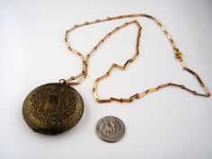 "Welcome to my Instagram account @Jewelrin Vintage/ Antique Old Metal Brass Unmarked Floral Locket Necklace Pendant. I believe this item to be made of brass but I could be mistaken. The locket shows overall wear including scratches and discoloration; the clasp still works well. The chain is made of goldtone metal. Measurements/size: The chain measures 27\" (68 cm). The locket measures 2\" (5 cm ) in diameter. Marks or signatures: Unsigned Condition - Very good vintage condition. Take a look at m Antique Gold Metal Locket Necklace, Vintage Gold Etched Locket Necklace, Victorian Gold Locket Necklace, Victorian Gold Metal Locket Necklace, Vintage Medallion Locket Necklace, Victorian Style Gold Metal Locket Necklace, Antique Gold Locket Necklace Nickel-free, Antique Gold Locket Necklace With Antique Finish, Antique Gold Medallion Locket Necklace Vintage Style