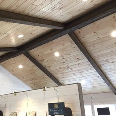 the inside of a building with wooden ceilings and beams on it's ceiling,