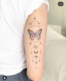 a woman's arm with a butterfly and stars tattoo on the left side of her arm