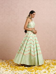 Featuring a one shoulder embroidered mint green blouse with gota and colourblocks. It is paired with a mint green embroidered lehenga and comes with a peach embroidered silk organza dupatta. Color: Mint Green and Peach Fabric: Lehenga & Blouse - Silk base Dupatta - Silk Organza Note: The product will be shipped within 30-35 days of order placed Wash care - Dry Clean Only. Do not use heavy Iron Spring Green Traditional Wear With Gota Work, Green Traditional Wear With Gota Work For Spring, Spring Wedding Traditional Wear With Gota Work, Spring Wedding Sharara With Gota Work, Spring Reception Traditional Wear With Zari Work, Green Traditional Wear With Dori Work For Spring, Spring Zari Work Lehenga In Traditional Drape, Spring Green Lehenga With Floral Embroidery, Green Floral Embroidered Lehenga For Spring