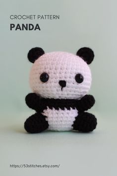 a crocheted panda bear sitting on top of a table