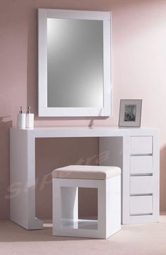 a white dressing table with mirror and stool