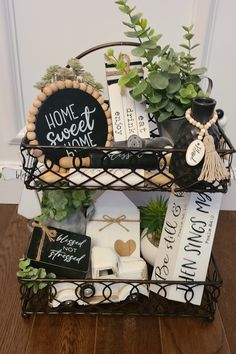 a basket filled with books and plants on top of a wooden floor