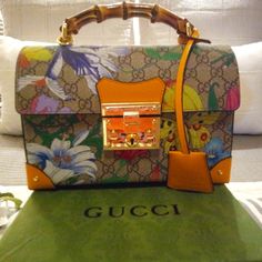 Stunning Gucci Bag Structured Coated Canvas Shoulder Bag Featuring Logo Pattern In Beige And Brown. Multicolor Floral Pattern And Grained Leather Trim In Yellow Throughout. Bamboo Carry Handle At Top. Detachable And Adjustable Curb Chain Shoulder Strap Featuring Leather Strap Pad And Lanyard Clasp Fastening. Sheathed Keys On Detachable Leather Lanyard At Strap Base. Studded Detailing At Back Face. Foldover Flap Featuring Logo-Engraved Press-Release Fastening At Main Compartment. Leather Logo Applique At Interior. Microsuede Lining In Tan. Bumper Studs At Base. 10"W X 6.5"H X 2"D 1.5" Handle Drop 21-23" Strap Drop Made In Italy Box & Dust-Bag Included Coa Included Leather Lanyard, Base 10, Logo Pattern, Canvas Shoulder Bag, Leather Logo, Gucci Handbags, Gucci Bags, Press Release, Curb Chain