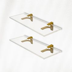 two white trays with gold handles on them