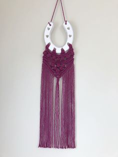 a purple and white decoration hanging on a wall