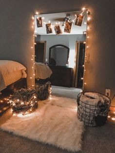 a bedroom with lights strung from the ceiling and rugs on the floor in front of it