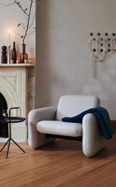 a living room with a chair and fireplace