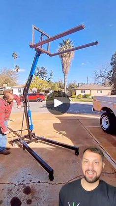 two men working on a metal structure in the middle of a parking lot with palm trees