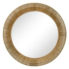 a round mirror that is made out of wood and has a rattan pattern on it