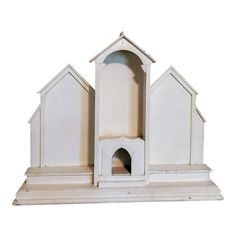 a small white dog house with a cat in it